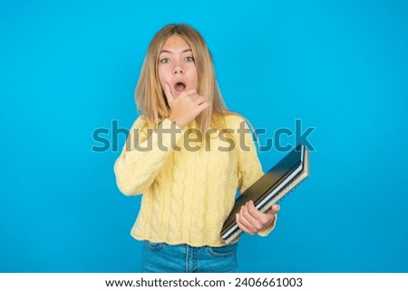 beautiful caucasian teen girl  Looking fascinated with disbelief, surprise and amazed expression with hands on chin