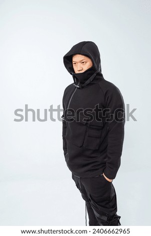photo shoot of a Korean guy on a white background. A Korean model in a fashionable winter hoodie. photo shoot of youth clothes with a model in a photo studio