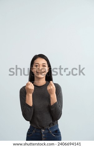Asian woman braces using dental floss. Teeth braces on the white teeth of women to equalize the teeth. Bracket system in smiling mouth, close up photo teeth, macro shot, dentist health concept. Royalty-Free Stock Photo #2406694141