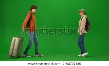 Portrait of person tourist isolated on chroma key green screen background. Young couple meets at the arrival area, man and girl smiling happy expression.