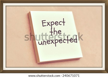 Text expect the unexpected on the short note texture background