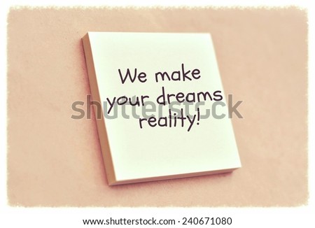 Text we make your dreams reality on the short note texture background