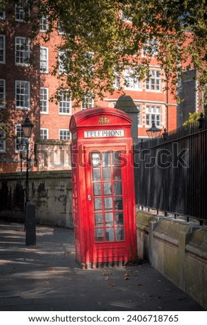 Vintage Red London Payphone Telephone in the City Royalty-Free Stock Photo #2406718765
