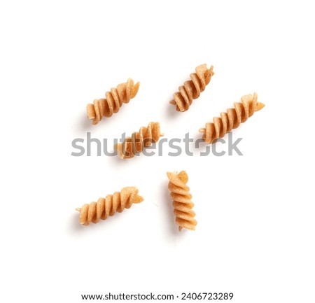 Raw Brown Pasta Isolated, Scattered Wholegrain Fusilli, Dry Whole Grain Noodle, Raw Spelt Macaroni, Healthy Italy Food, Organic Meal, Wholewheat Spiral Pasta on White Background Top View Royalty-Free Stock Photo #2406723289