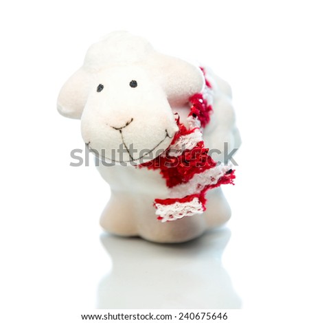 White sheep toy the Chinese symbol of 2015 year on white background. Selective focus on sheep