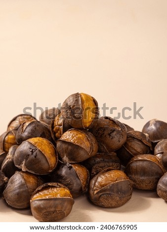 Cooked chestnuts (Castanea mollissima Blume) and sugar-fried chestnuts are popular Chinese street snacks with a sweet taste. Close-up of peeled chestnut Royalty-Free Stock Photo #2406765905