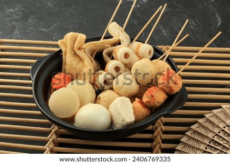 Japanese Homemade oden FIsh Ball Fstive Soup with Dashi Stock, Served on Black Nabe