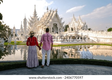 White Temple Chiang Rai Thailand, a diverse couple of men and women visit Wat Rong Khun temple or the white temple in Northern Thailand. Royalty-Free Stock Photo #2406770597