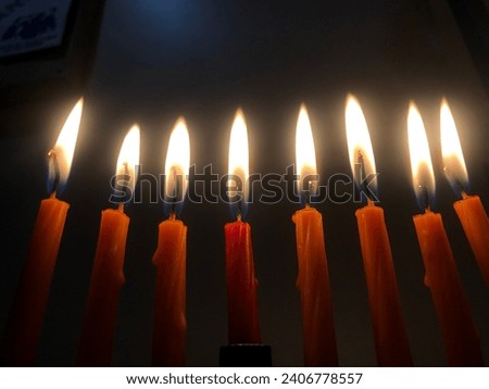 Chanukah candles burn brightly dispelling the darkness