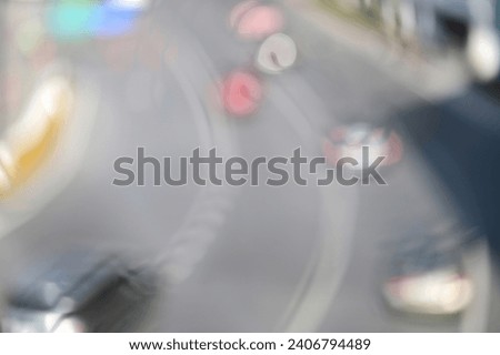 Blurred image of a car driving on the road and bokeh from lens melting for wallpaper, backdrop and design.