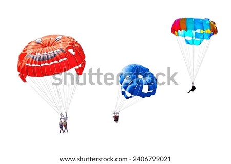 Three different images of skydivers on colorful parachutes isolated on a white background Royalty-Free Stock Photo #2406799021
