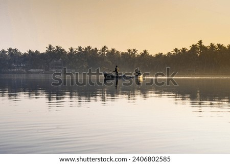 Fisherman with traditional boat, Beautiful landscape view from Kannur Kavvayi Island, Kerala backwaters scenery Royalty-Free Stock Photo #2406802585