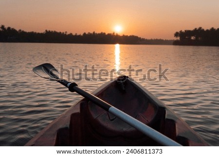 canoe silhouette view, Kayak on the river during sunrise, Kavvayi island water adventure photo Royalty-Free Stock Photo #2406811373