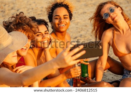 mixed race people taking photos and video together on smartphone camera