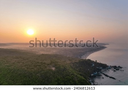Aerial view of mountain peak and sea and sunset colorful sky from above from drone