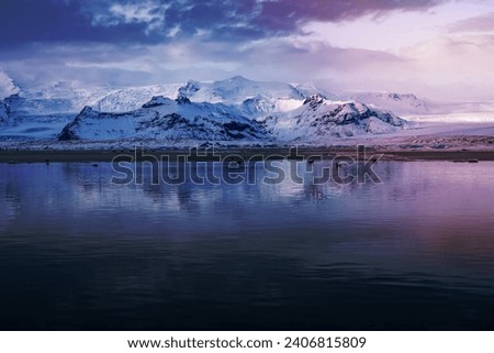 Beautiful Winter Landscape. Glacial Lake with Icebergs and Birds in it. Gorgeous Great Mountains Covered with Snow. Vantajokull Jokulsarlon. Iceland.