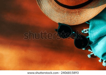 Conceptual photo of a summer vacation and relaxation. Sunglasses, sunhat, beach towel. Summer holidays border. Travel background with space for text
