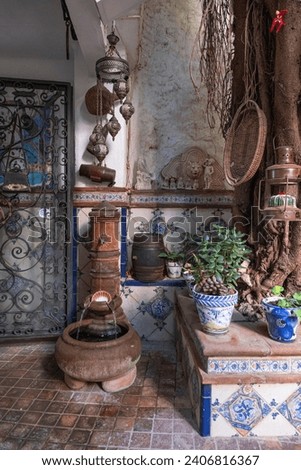 Calm spanish courtyard with fountain and memorabilia classic environement old ancient garden Royalty-Free Stock Photo #2406816367