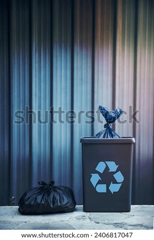 Photo of a Sorted Garbage in the Plastic Biodegradable Bags. Trash Can over Steel Background. Recycle to Save the Planet from Waste and Pollution.