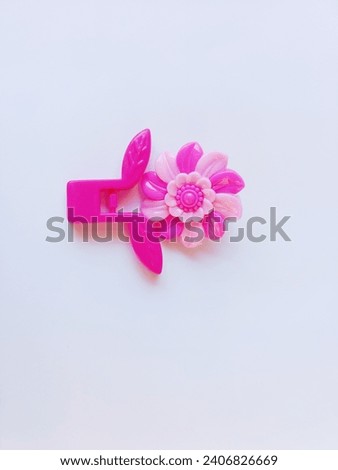 Pink children's hair clip on a white background