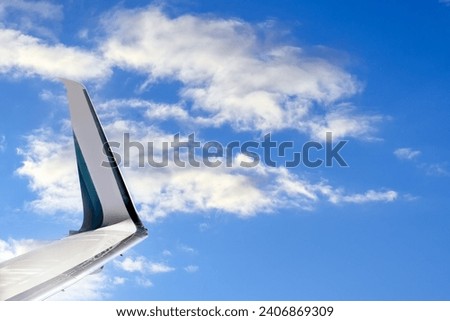 Winglet of a plane in blue sky Royalty-Free Stock Photo #2406869309