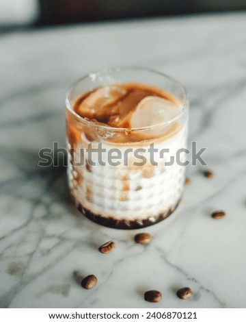 A picture of an iced coffee with milk