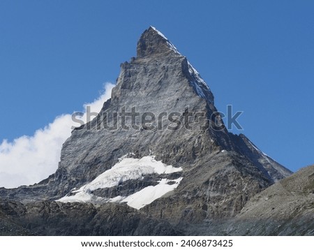 Famous Matterhorn, Cervino mountain, 4 478 m at European Alps at canton Valais in Switzerland, clear blue sky in 2018 warm sunny summer day on August. Royalty-Free Stock Photo #2406873425