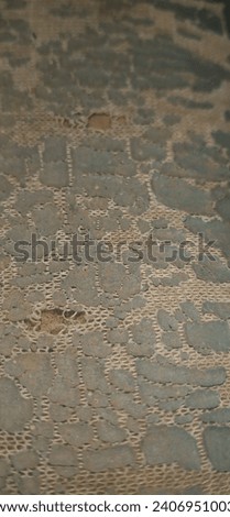 A picture of a carpet that is worn with age