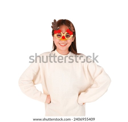 Happy young asian woman smiling with both hands on her hips while wearing Christmas glasses against a white background