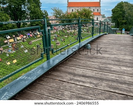 Zamosc, Poland, September 3, 2023: Padlocks fastened to railings along walking paths around the city of Zamosc, Poland as a souvenir and symbol of bonding.