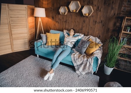High angle view full size photo of nice girl sit couch arms behind head closed eyes have good mood loft flat inside Royalty-Free Stock Photo #2406990571