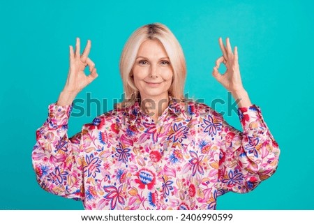 Photo of shiny sweet woman dressed print shirt showing two okey signs isolated turquoise color background