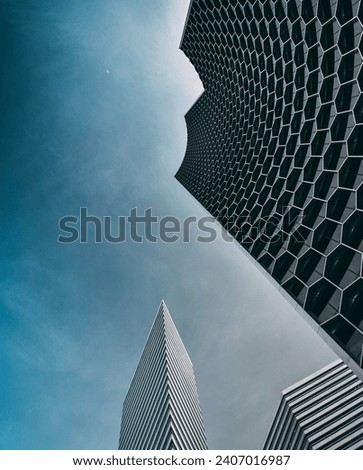 Duo Galleria and Gateway Towers scrape the sky in Singapore, forming a geometrical silhouette of futuristic, cutting edge architectural masterpieces by Ole Scheeren and IM Pei Royalty-Free Stock Photo #2407016987