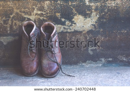 still life with boots on old background