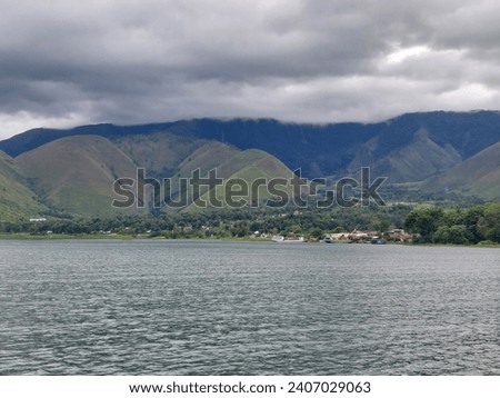 Beautiful views of natural lakes and hills during the day. The calm waters of Lake Toba, the largest lake in Southeast asia. Indonesia.