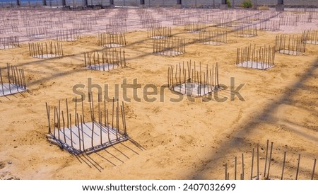 Deep Foundation Footing Reinforcement Steel on the Ground for reinforced Concrete Floor work in the Construction Site of Large Industrial Building Royalty-Free Stock Photo #2407032699