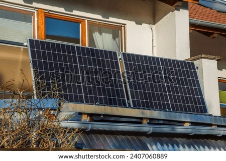 Balcony solar power plant. Solar battery on balcony wall. Mini PV plants generate your own electricity plug play. Royalty-Free Stock Photo #2407060889