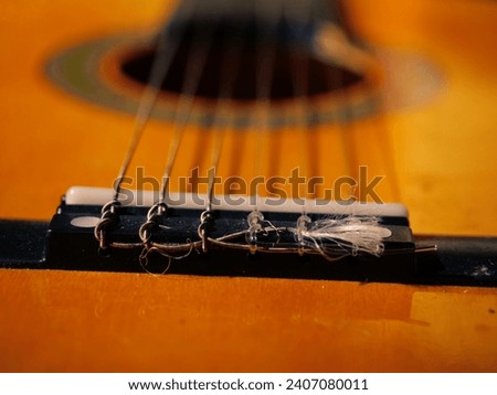 Classical guitar strings and frets close up shot selective focus Royalty-Free Stock Photo #2407080011