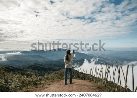 A young woman travels to Doi Inthanon, the highest mountain in Thailand, in winter. Royalty-Free Stock Photo #2407084629