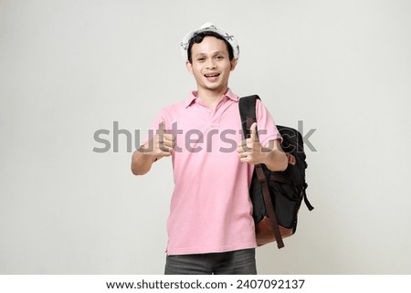 Asian man backpacker give thumb up gesture. digital nomad and travelling concept. on isolated background