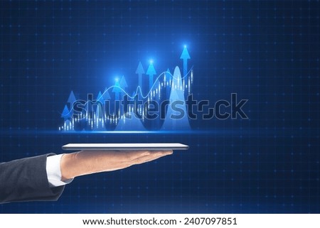 Close up of male hand holding tablet with growing forex chart with bright upward arrow on blurry pixel background. Success, financial growth and trade concept