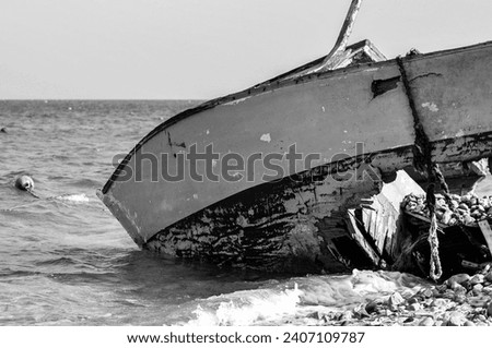 Sea's silent siren song sings to a forgotten soul. Black and White beauty of an abandoned boat, secrets etched in every weathered plank.