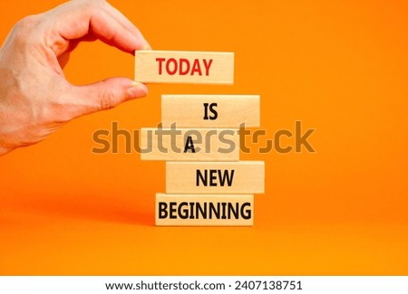 Today is a new beginning symbol. Concept words Today is a new beginning on wooden blocks. Beautiful orange background. Businessman hand. Business today is a new beginning concept. Copy space.