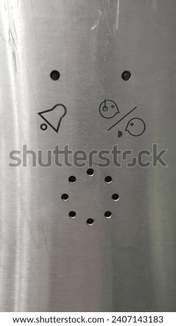 On the metal panel in the elevator: holes for negotiations with the operator, two light bulbs - one with a bell pattern, the other with a schematic drawing of two talking people