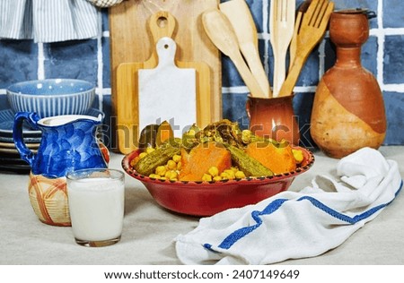 Meat and vegetable couscous in a tajine plate, milk. typical food from Algeria, a traditional festive Arabic dish with herbs and spices in the kitchen Royalty-Free Stock Photo #2407149649