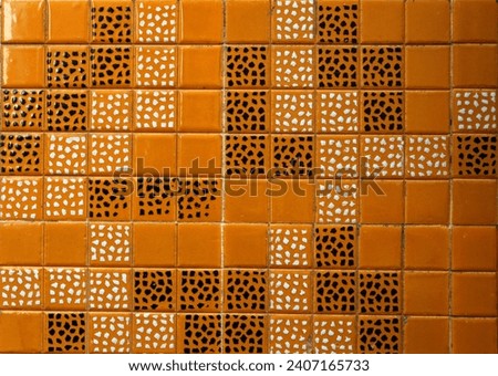 Texture of orange ceramic tiles with speckled geometric pattern, good background