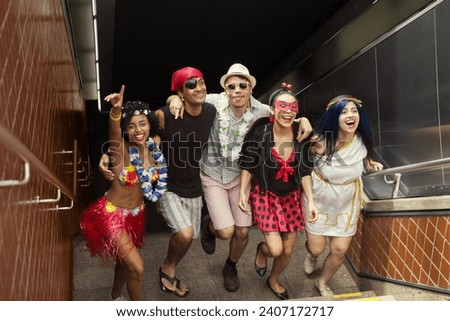 Carnaval party. Group of Brazil friends in costume celebrating carnival in the city. Dressed brazilian partygoers having fun in parade festival. Royalty-Free Stock Photo #2407172717