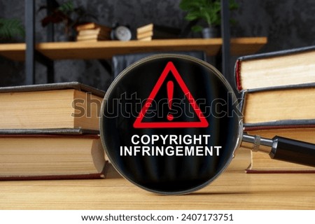 Books and magnifying glass with inscription Copyright infringement. Royalty-Free Stock Photo #2407173751