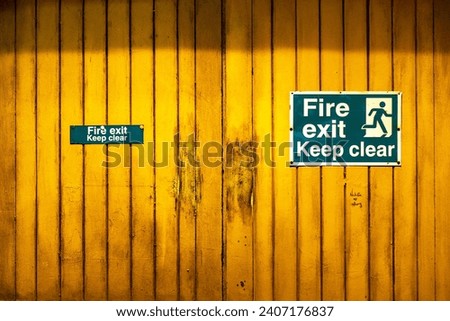 Fire exit, keep clear sign on yellow door