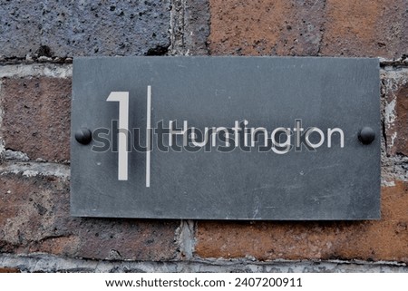 1 Huntington. Welsh slate door numbers and names on a victorian brick wall
